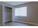 Bright bedroom featuring wood floors, a closet, and a large window allowing ample natural light at 3575 Oakvale Rd # 305, Decatur, GA 30034