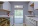 Well-lit kitchen with stainless steel appliances, white cabinets, and marble countertops at 3575 Oakvale Rd # 305, Decatur, GA 30034