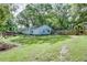 Large backyard with a grass lawn, mature trees, and a wooden fence at 4236 Florida Nw Ave, Atlanta, GA 30360