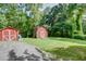 Large backyard featuring lawn and storage sheds at 4236 Florida Nw Ave, Atlanta, GA 30360