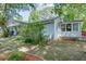 Side view of home showcasing siding, a small porch, and landscaping at 4236 Florida Nw Ave, Atlanta, GA 30360