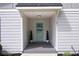 Close up view of the entrance featuring a stylish blue front door, potted plants, and modern design at 1251 Pierce Ave, Smyrna, GA 30080