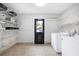 Well-organized laundry room featuring shelving, washer, and dryer for convenience at 1251 Pierce Ave, Smyrna, GA 30080