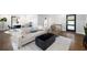 Open-concept living room with modern furniture, hardwood floors, and access to the dining area at 1251 Pierce Ave, Smyrna, GA 30080
