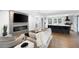 Open-concept living room and kitchen featuring sleek modern furniture, fireplace, and hardwood floors at 1251 Pierce Ave, Smyrna, GA 30080