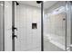 Contemporary glass enclosed walk-in shower with black fixtures and custom tile surround at 1251 Pierce Ave, Smyrna, GA 30080