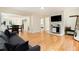 Bright living room featuring hardwood floors and a stylish stone accent wall with mounted TV at 361 Adelle Se St, Atlanta, GA 30315