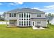 Exterior of house and backyard featuring a lush lawn, outdoor patio and dining area at 4105 Vista Pointe Dr, Cumming, GA 30028