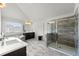 Bathroom featuring a bathtub, glass door shower, and large window at 4105 Vista Pointe Dr, Cumming, GA 30028