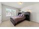 Cozy bedroom with a bed, storage headboard, and natural light from the window at 4105 Vista Pointe Dr, Cumming, GA 30028