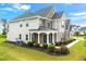 A well-maintained two-story home features an inviting covered porch and lush landscaping at 4105 Vista Pointe Dr, Cumming, GA 30028