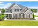 Charming brick and stone home with a manicured lawn and covered front porch at 4105 Vista Pointe Dr, Cumming, GA 30028