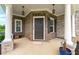 Inviting front porch with brick accents, stone columns, and stylish lighting fixtures at 4105 Vista Pointe Dr, Cumming, GA 30028