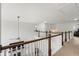 Hallway with wood railing overlooking the living room fireplace and built-ins at 4105 Vista Pointe Dr, Cumming, GA 30028