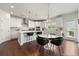 Modern kitchen with an island, marble table, stainless steel appliances, and white cabinets at 4105 Vista Pointe Dr, Cumming, GA 30028