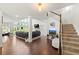 Open-concept living room with a two-story window wall, hardwood floors, and staircase at 4105 Vista Pointe Dr, Cumming, GA 30028