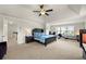 Main bedroom with tray ceilings, large windows, and carpet at 4105 Vista Pointe Dr, Cumming, GA 30028