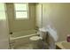 An all-white bathroom with a tub, a toilet, and a sink at 1487 Colony East Cir, Stone Mountain, GA 30083