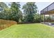 Well-maintained backyard features lush green grass and a sturdy wooden fence, providing a private outdoor space at 2183 Trinity Grove Ct, Dacula, GA 30019
