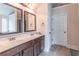 Bathroom features a double sink vanity, large mirrors, and tiled floors for a clean, modern aesthetic at 2183 Trinity Grove Ct, Dacula, GA 30019