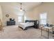 Spacious bedroom with high ceilings, carpet, a ceiling fan, and large windows provides natural light and comfort at 2183 Trinity Grove Ct, Dacula, GA 30019
