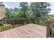 Spacious wooden deck with brown railings offering a serene outdoor living space and backyard views at 2183 Trinity Grove Ct, Dacula, GA 30019
