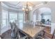 Spacious dining room boasts a grand table, decorative chandelier, and abundant natural light, creating a welcoming atmosphere at 2183 Trinity Grove Ct, Dacula, GA 30019