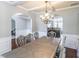Open-concept dining room with decorative chandelier, view of the living room, and ample seating perfect for entertaining at 2183 Trinity Grove Ct, Dacula, GA 30019