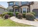 Charming two-story brick home with a well-manicured lawn and walkway to front door at 2183 Trinity Grove Ct, Dacula, GA 30019