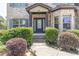 Charming brick home with a well-manicured lawn and walkway to front door at 2183 Trinity Grove Ct, Dacula, GA 30019