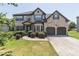 Charming two-story brick home with a well-manicured lawn and an attached two-car garage at 2183 Trinity Grove Ct, Dacula, GA 30019