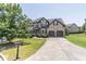 Charming two-story brick home with a well-manicured lawn, driveway, and inviting curb appeal at 2183 Trinity Grove Ct, Dacula, GA 30019