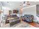 Open-concept living room with hardwood floors, a stone fireplace, and seamless connection to the kitchen at 2183 Trinity Grove Ct, Dacula, GA 30019