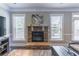 Cozy living room with a stone fireplace and natural light at 2183 Trinity Grove Ct, Dacula, GA 30019
