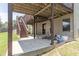 Back patio beneath deck with stairs to yard, great for entertaining or relaxing outdoors in a shady space at 2183 Trinity Grove Ct, Dacula, GA 30019