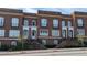 Charming brick townhomes with white trim and arched doorways, offering a classic and inviting facade at 5139 Peachtree Road, Chamblee, GA 30341