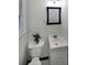 Small bathroom with a black framed mirror, white sink, and a toilet with a plant at 1403 Dennis Dr, Decatur, GA 30032