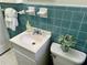 Cozy bathroom featuring blue tiling, a white sink vanity, and decorative touches at 1403 Dennis Dr, Decatur, GA 30032
