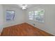 Bedroom showcasing hardwood floors, ceiling fan and well-lit windows with blinds at 1403 Dennis Dr, Decatur, GA 30032