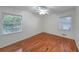 Bedroom with hardwood floors, ceiling fan and two windows allowing ample natural light at 1403 Dennis Dr, Decatur, GA 30032