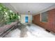 Attached carport area with concrete flooring and a bright blue door providing access to the house at 1403 Dennis Dr, Decatur, GA 30032