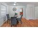 Bright dining room features hardwood floors, a glass table with seating for four, and modern decor at 1403 Dennis Dr, Decatur, GA 30032