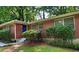 Charming brick home featuring a bright blue front door and well-maintained landscaping at 1403 Dennis Dr, Decatur, GA 30032