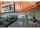 Stylish kitchen counter with granite countertops, tiled backsplash, stainless steel appliances, and modern accessories at 1403 Dennis Dr, Decatur, GA 30032