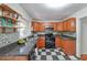 Updated kitchen with stainless steel appliances, granite countertops, wooden cabinets, and checkerboard floors at 1403 Dennis Dr, Decatur, GA 30032