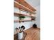 Open shelving in kitchen area features wood shelves, butcher block countertop, and modern accessories at 1403 Dennis Dr, Decatur, GA 30032