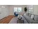 Bright living room with hardwood floors, with a modern gray sofa at 1403 Dennis Dr, Decatur, GA 30032