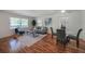 Well-lit living room with hardwood floors, and a gray sofa accented with patterned pillows at 1403 Dennis Dr, Decatur, GA 30032