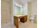 Bathroom featuring a shower, vanity, and toilet with neutral tile flooring at 3533 Mulberry Way, Duluth, GA 30096