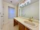 Bathroom vanity with a large mirror and vanity lighting, and wood-look cabinetry at 3533 Mulberry Way, Duluth, GA 30096